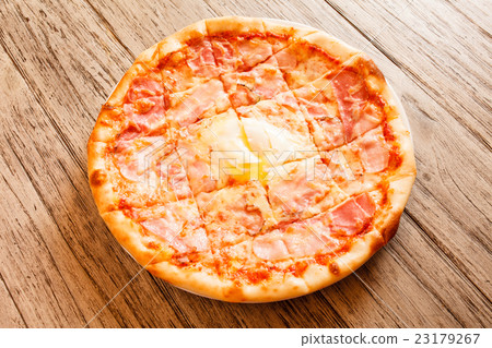 pizza on wooden background 23179267