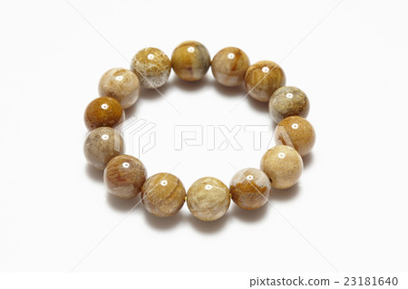 Lucky stone bracelet on white background. 23181640