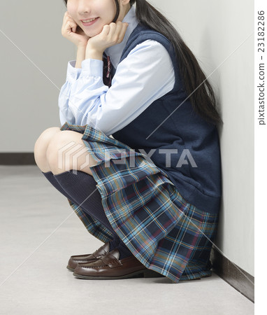 High school girls crouching in the hallway High school girls crouching in the hallway 23182286