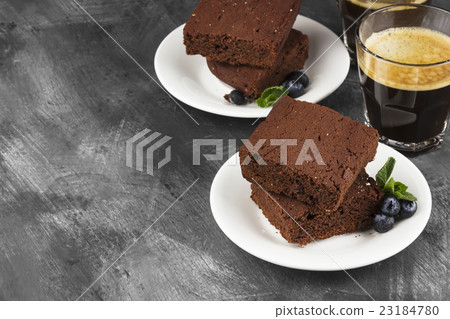 Brownie pieces and coffee on a dark background 23184780
