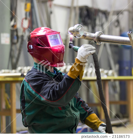 Industrial worker welding in metal factory. 23186573