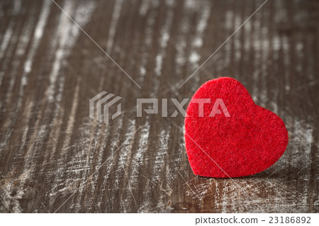 Red felt heart on wooden background. Red felt heart on wooden background. 23186892