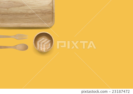 Wooden kitchenware on yellow background  23187472