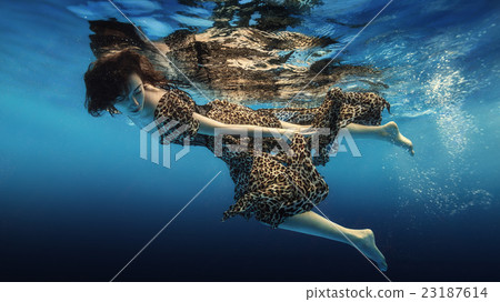 The girl in a colorful dress under water The girl in a colorful dress under water 23187614