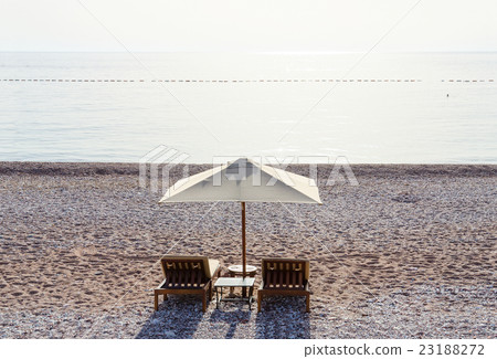 Sunbeds on sandy beach in sultry day, Montenegro Sunbeds on sandy beach in sultry day, Montenegro 23188272