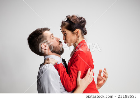 The business man and woman communicating on a gray The business man and woman communicating on a gray 23188653