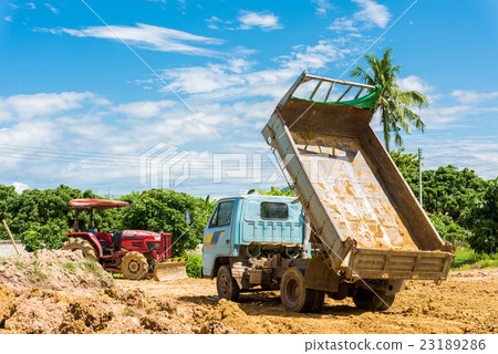 Dump truck unloading soil at construction site Dump truck unloading soil at construction site 23189286