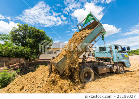 Dump truck unloading soil at construction site Dump truck unloading soil at construction site 23189327