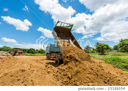 Dump truck unloading soil at construction site Dump truck unloading soil at construction site 23189354