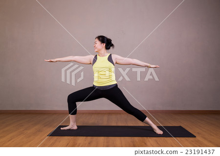 Female performing the Warrior 2 yoga pose Female performing the Warrior 2 yoga pose 23191437