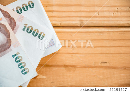 Thai money on wooden table. 23191527