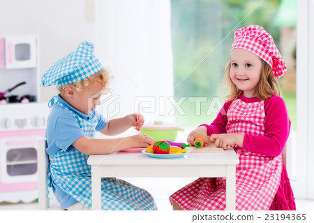Kids playing with toy kitchen Kids playing with toy kitchen 23194365