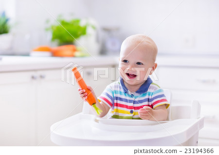 Little baby eating carrot Little baby eating carrot 23194366