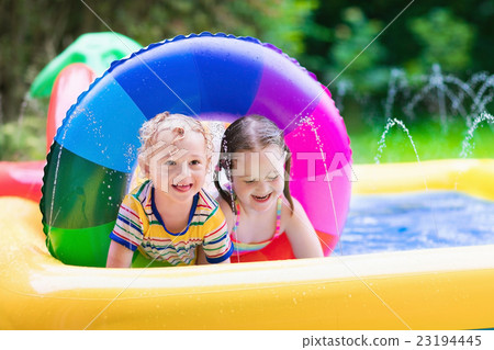 Kids playing in garden swimming pool 23194445