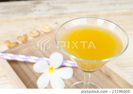 Orange juice in glass on wooden background Orange juice in glass on wooden background 23196808