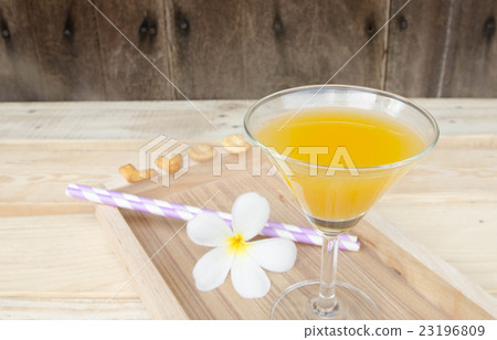 Orange juice in glass on wooden background Orange juice in glass on wooden background 23196809