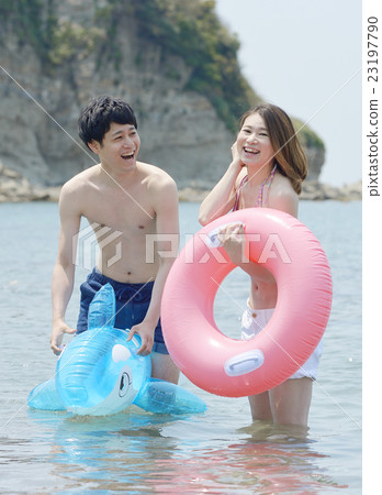 Young couple playing in the sea Young couple playing in the sea 23197790