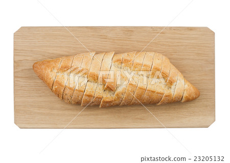 White small bread being cut on wooden board White small bread being cut on wooden board 23205132