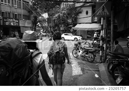 black and white traveller walking on the street 23205757