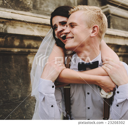 groom carries bride on his back groom carries bride on his back 23208302