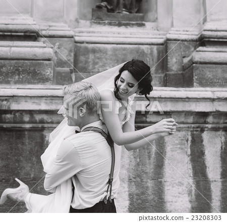 groom carries bride in his arms groom carries bride in his arms 23208303