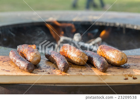 Grilling sausages on barbecue grill 23209538