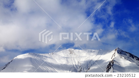 Panoramic view on off-piste snowy slope  wind day 23210512