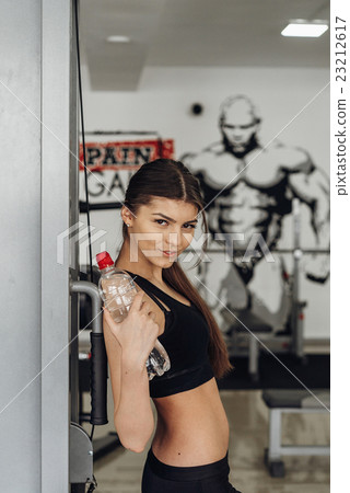 Beautiful girl with water at the gym Beautiful girl with water at the gym 23212617