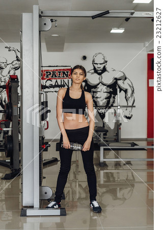 Beautiful girl with water at the gym 23212627