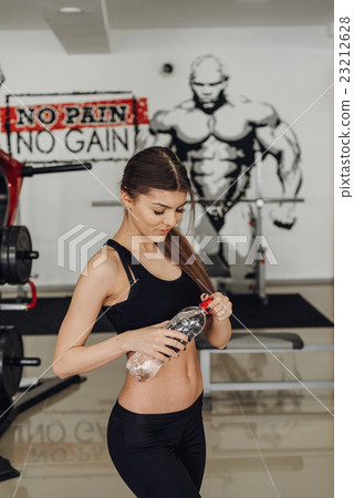 Beautiful girl with water at the gym Beautiful girl with water at the gym 23212628