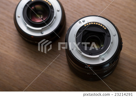 Camera lens on wooden table 23214291