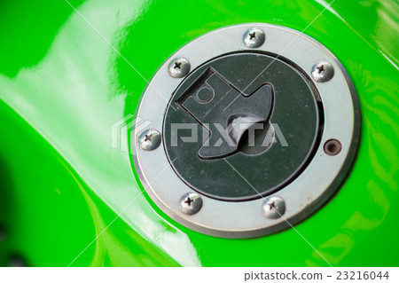 Green motorbike and chrome fuel cap, close up 23216044