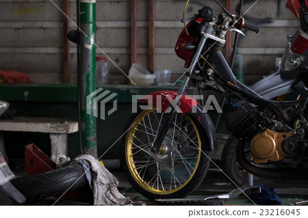 Motorbike in repair garage 23216045