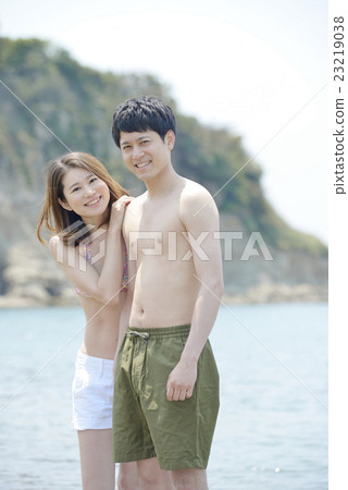 A couple nestling at the beach A couple nestling at the beach 23219038