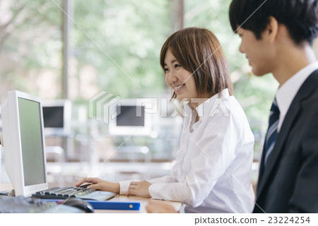 Business woman heading for PC with a smile 23224254