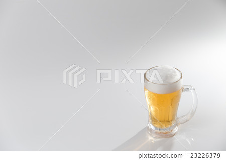 Beer poured into mugs · white back Beer poured into mugs · white back 23226379