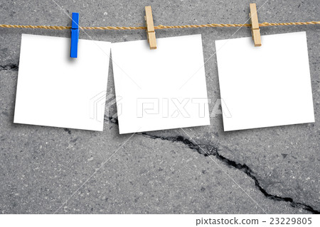 Blank placard paper hanging with background cracks 23229805