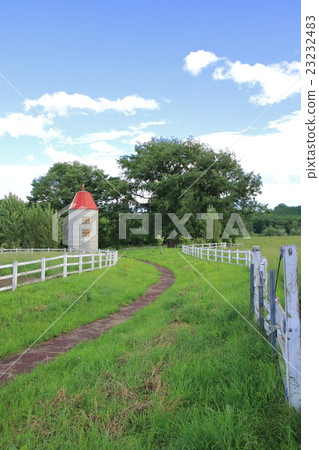 Idyllic landscape of Hokkaido silo and pasture fence 23232483