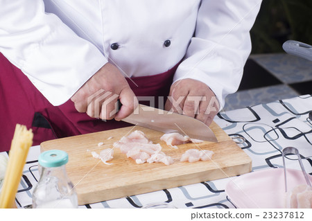Chef prepared cutting chicken before cooking 23237812