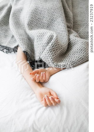 Fully covered woman except hands in bed 23237919