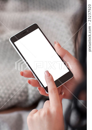 Empty screen of smartphone in womans hands 23237920