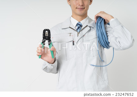 Worker with LAN cable and crimping pliers 23247652