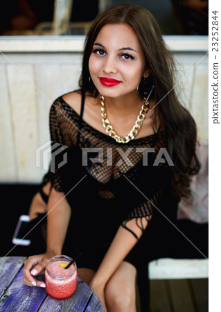 Charming female enjoying fruit smoothie 23252844