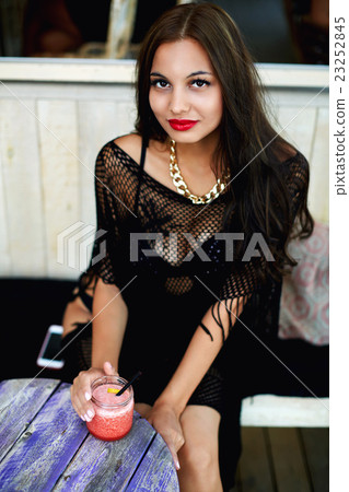 Pretty female enjoying fruit smoothie 23252845