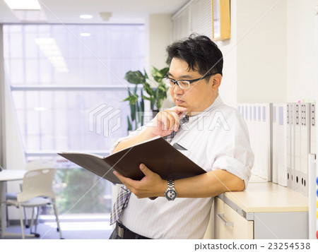 Businessmen looking at files and thinking 23254538