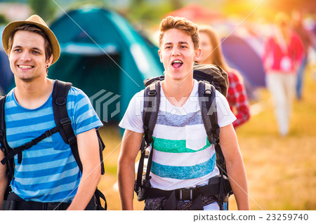 Two teenage boys with backpacks arriving at music Two teenage boys with backpacks arriving at music 23259740