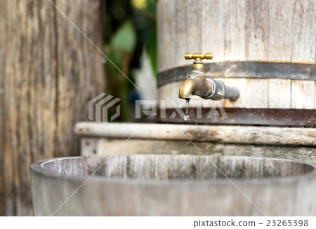 Concept saving wooden water tank with golden tap Concept saving wooden water tank with golden tap 23265398