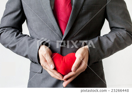Businessman showing compassion holding red heart 23266448