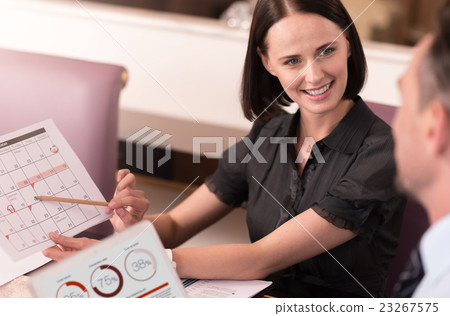 Positive colleagues sitting at the table 23267575