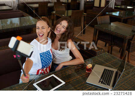 Women making photo with smart phone camera Women making photo with smart phone camera 23271428